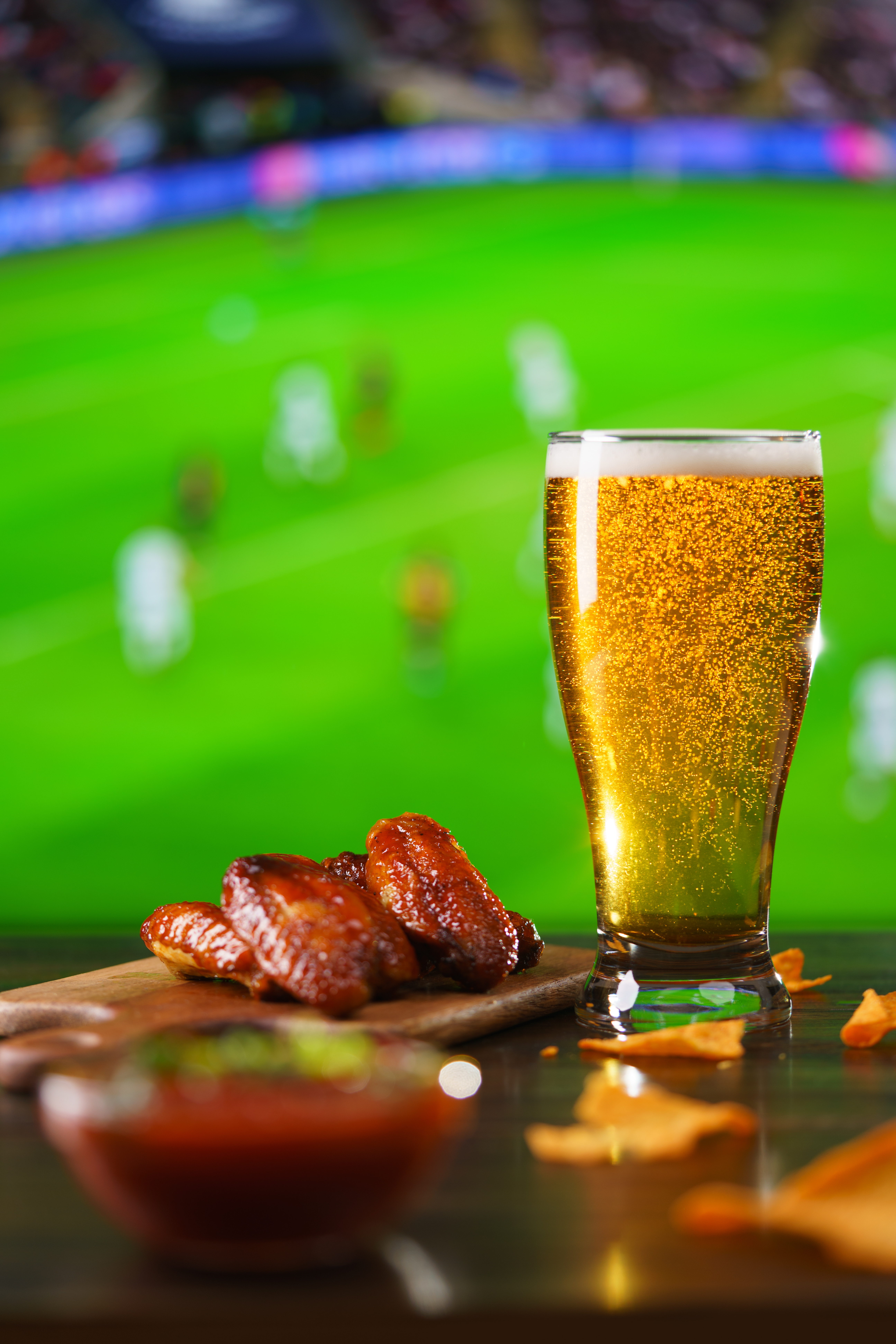 Spicy Barbecue Chicken Wings, Tomato Salsa, Nachos And Beer On Dark Wooden Bar Table. Football On Background, High Resolution